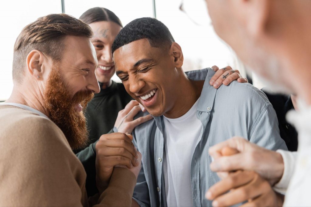 Group of people laughing together showing joy and social connection for better mental and brain health